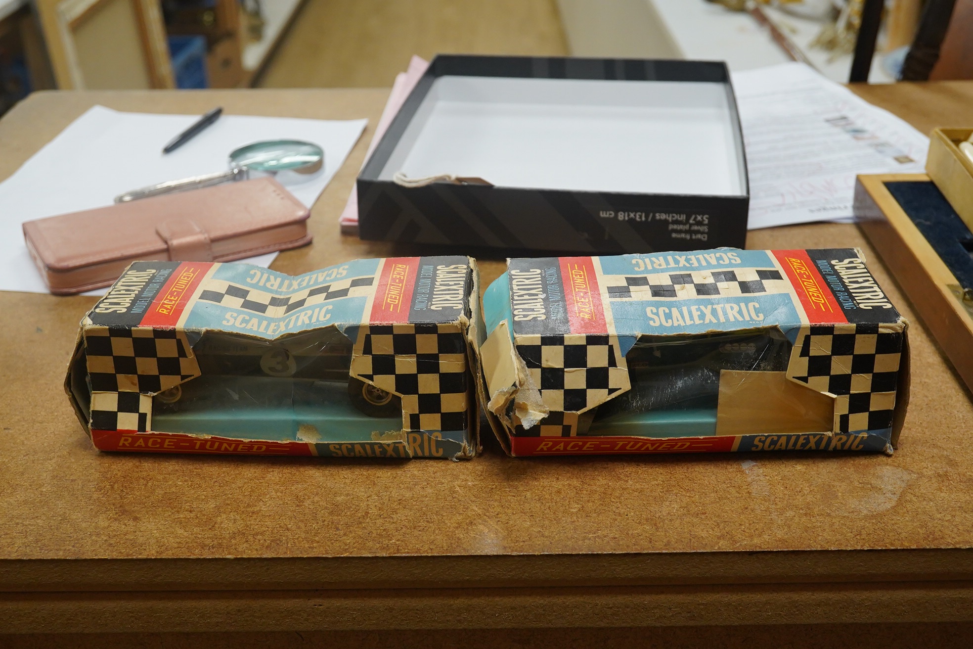 Two boxed 1960s Scalextric ‘race-tuned’ racing cars; a Lotus Indianapolis GP (C8) and a Scalextric Team Car (C19), both with inner card trays. Condition - poor, restoration needed to cars and boxes.